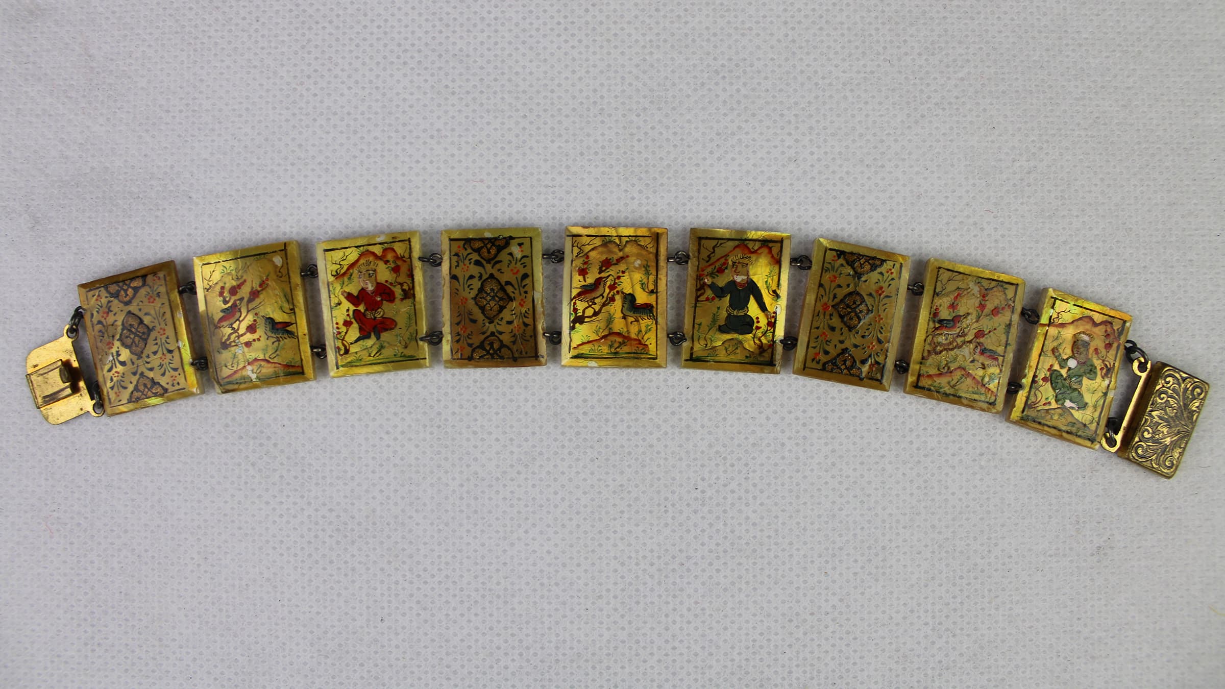 A Persian mother of pearl bracelet featuring hand-painted miniatures. 