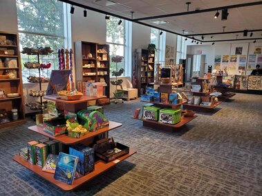 Inside of Discovery Gift Shop and stands and shelves of merchandise