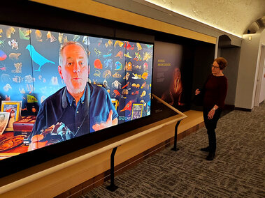Woman looking at video board of the Photo Ark